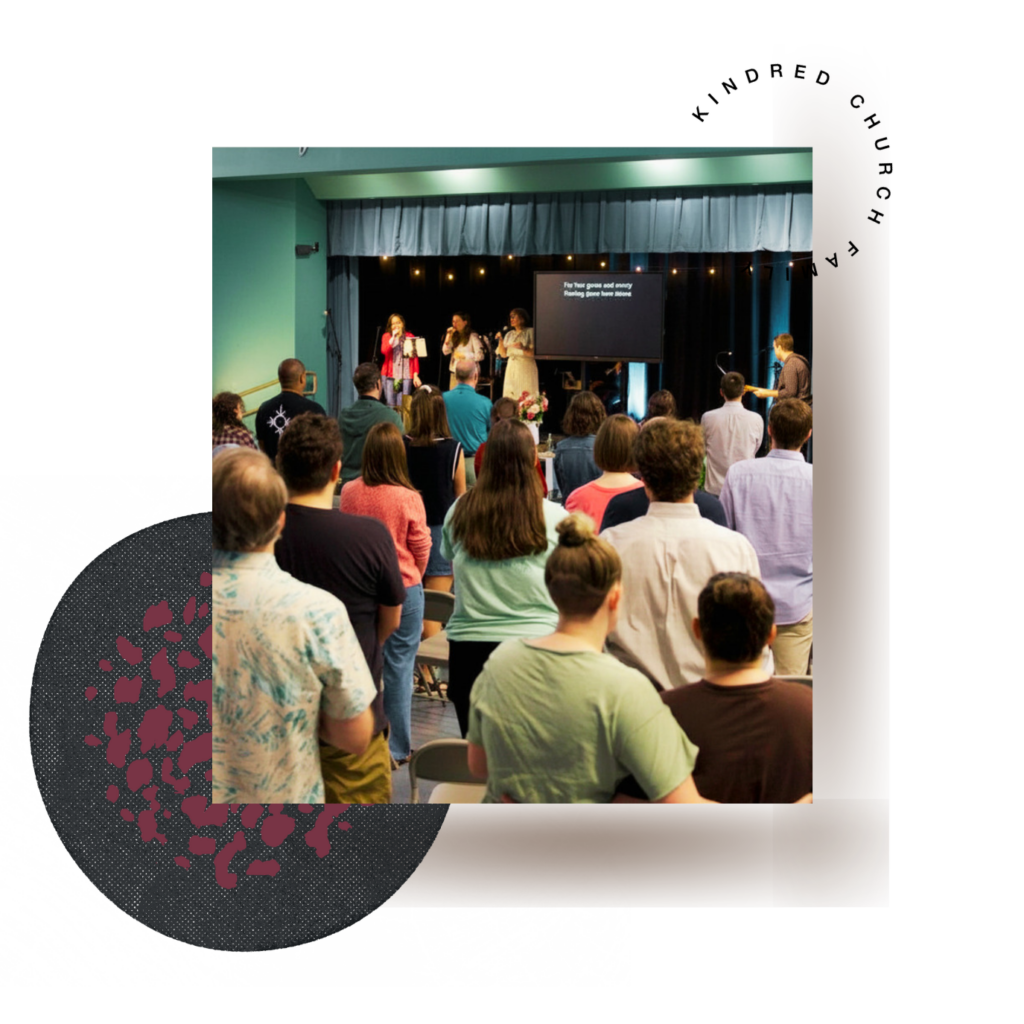 Kindred Church congregation standing and singing with onstage band during Sunday worship
